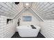 Bright bathroom boasting a modern tub, skylight, white tile and black honeycomb tile flooring at 415 S Oxford St, Indianapolis, IN 46201