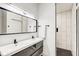 Modern bathroom featuring a double sink vanity, a walk-in shower with black and white tiles and sleek fixtures at 415 S Oxford St, Indianapolis, IN 46201