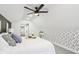 Cozy bedroom featuring a ceiling fan, white walls, and accent wall with geometric patterns at 415 S Oxford St, Indianapolis, IN 46201