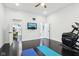Spacious bonus room with dark hardwood floors and exercise equipment for wellness activities at 415 S Oxford St, Indianapolis, IN 46201