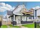 Inviting two-story home with a rooftop deck, fresh exterior paint, and lush green lawn at 415 S Oxford St, Indianapolis, IN 46201