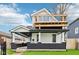 Well-maintained home showcasing a rooftop deck, classic architecture, and green lawn at 415 S Oxford St, Indianapolis, IN 46201