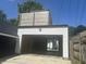 White two-car garage exterior with an upper-level deck at 415 S Oxford St, Indianapolis, IN 46201