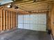 Spacious two car garage with automatic door, bare stud walls, and concrete floor offers ample space for vehicles and storage at 415 S Oxford St, Indianapolis, IN 46201