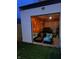 Open garage converted to lounge area with modern seating, heater, and a black sports car at 415 S Oxford St, Indianapolis, IN 46201
