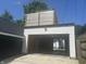 White two-car garage exterior with an upper-level deck at 415 S Oxford St, Indianapolis, IN 46201
