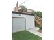 Exterior view of a white garage with a door, alongside a deck and staircase, with artificial turf in the backyard at 415 S Oxford St, Indianapolis, IN 46201