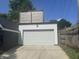 White two-car garage exterior with an upper-level deck at 415 S Oxford St, Indianapolis, IN 46201