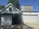 Two-car garage with black and white exterior, including upper-level deck access at 415 S Oxford St, Indianapolis, IN 46201