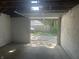 Unfinished two-car garage interior with open door that looks out to the driveway at 415 S Oxford St, Indianapolis, IN 46201