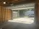 Unfinished two-car garage interior with open door that looks out to the driveway at 415 S Oxford St, Indianapolis, IN 46201