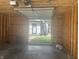 Unfinished two-car garage interior with open door that looks into the backyard at 415 S Oxford St, Indianapolis, IN 46201