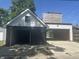 Two-car garage with black and white exterior with upper-level deck access at 415 S Oxford St, Indianapolis, IN 46201