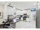 Modern kitchen boasts white cabinets, black countertops, stainless steel appliances, and a stylish island with seating at 415 S Oxford St, Indianapolis, IN 46201
