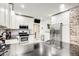 Bright kitchen with white cabinets, stainless steel appliances, black countertops, and subway tile backsplash at 415 S Oxford St, Indianapolis, IN 46201