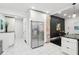 Bright kitchen boasts white cabinets, stainless steel appliances, black countertops, and marble tile flooring at 415 S Oxford St, Indianapolis, IN 46201
