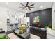 Modern living room boasts an open floor plan, black accent wall, bar seating, and hardwood floors at 415 S Oxford St, Indianapolis, IN 46201