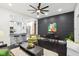 Modern living room boasts an open floor plan, black accent wall, bar seating, and hardwood floors at 415 S Oxford St, Indianapolis, IN 46201