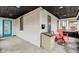 Charming front porch with secure package drop, a blue door, and two red chairs at 415 S Oxford St, Indianapolis, IN 46201