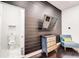 Chic space featuring a bold accent wall, modern decor, and an adjacent half-bath for added convenience at 415 S Oxford St, Indianapolis, IN 46201