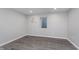 Finished basement with modern gray floors, neutral paint, and window at 4421 Brittany Dr, Zionsville, IN 46077