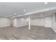 Spacious basement showcasing a finished design with new flooring and lighting at 4421 Brittany Dr, Zionsville, IN 46077