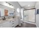 Well-appointed bathroom with a double vanity, modern fixtures, and a glass-enclosed shower at 4421 Brittany Dr, Zionsville, IN 46077