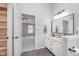 Stylish bathroom with double sinks, wood-look flooring, and a convenient walk-in closet at 4421 Brittany Dr, Zionsville, IN 46077