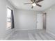 Light-filled bedroom with neutral walls, ceiling fan, and plush carpeting at 4421 Brittany Dr, Zionsville, IN 46077