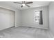 Well-lit bedroom features a ceiling fan, closet, and window bringing in natural light at 4421 Brittany Dr, Zionsville, IN 46077