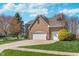 Beautiful brick home with three-car garage and landscaped front yard at 4421 Brittany Dr, Zionsville, IN 46077