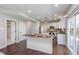Bright kitchen that leads into a living room area, hardwood floors, and sliding glass door at 4421 Brittany Dr, Zionsville, IN 46077