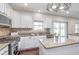 Bright kitchen with white cabinets, granite countertops, and stainless appliances at 4421 Brittany Dr, Zionsville, IN 46077