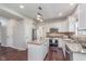 Bright kitchen features stainless appliances, granite countertops, island, and hardwood flooring at 4421 Brittany Dr, Zionsville, IN 46077
