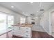 Open-concept living room and kitchen area with hardwood floors, fireplace, and lots of natural light at 4421 Brittany Dr, Zionsville, IN 46077