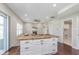 Open concept living room with kitchen island, carpeted floors, and a fireplace at 4421 Brittany Dr, Zionsville, IN 46077