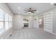 Bright living room with fireplace, large window, built-in shelving and carpeted floors at 4421 Brittany Dr, Zionsville, IN 46077