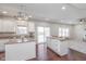 Bright and open living room with kitchen, fireplace, hardwood floors, and a sliding glass door at 4421 Brittany Dr, Zionsville, IN 46077