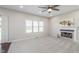 Spacious living room with fireplace, large window, and sliding glass door for easy access to outdoor living at 4421 Brittany Dr, Zionsville, IN 46077