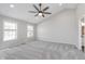 Spacious bedroom with vaulted ceiling, ample natural light, and plush carpeting at 4421 Brittany Dr, Zionsville, IN 46077
