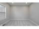 Minimalist room offers neutral colors, plush carpeting, and natural light with views of the outdoors at 4421 Brittany Dr, Zionsville, IN 46077