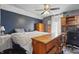 Comfortable bedroom featuring a ceiling fan and a mix of vintage and modern furnishings at 443 S Arlington Ave, Indianapolis, IN 46219