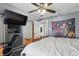 Well-lit bedroom features a TV and closet for storage at 443 S Arlington Ave, Indianapolis, IN 46219