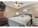 Comfortable bedroom with a large bed, ceiling fan, a window, and natural light at 443 S Arlington Ave, Indianapolis, IN 46219