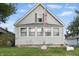 Charming gray home featuring a quaint front yard with a delightful American flag at 443 S Arlington Ave, Indianapolis, IN 46219