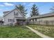 Charming two-story home with a cozy front porch, fenced yard, and mature trees, perfect for outdoor enjoyment at 443 S Arlington Ave, Indianapolis, IN 46219