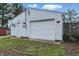 View of the exterior of the detached single car garage with white door at 443 S Arlington Ave, Indianapolis, IN 46219