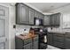 Well-lit kitchen features dark cabinets, wood countertop, stainless steel appliances, and tiled backsplash at 443 S Arlington Ave, Indianapolis, IN 46219