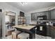 Open concept kitchen features a dark island with seating, cabinets, and appliances at 443 S Arlington Ave, Indianapolis, IN 46219