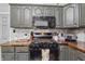 Charming kitchen with gray cabinets and stainless steel oven at 443 S Arlington Ave, Indianapolis, IN 46219